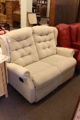 Two seater reclining wing back settee.