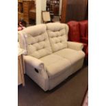 Two seater reclining wing back settee.