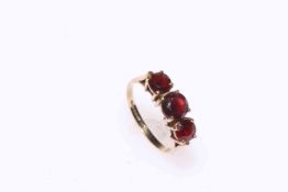 9 carat gold, three garnet ring, size O.