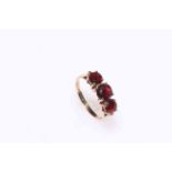 9 carat gold, three garnet ring, size O.