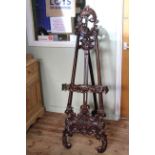 Ornately carved easel.