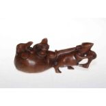Chinese carving of a rat with money sack.