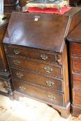Period style oak four drawer bureau, 102.5cm by 67cm.