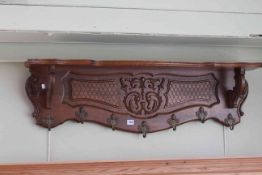 Carved oak seven hook coat rack, 109cm long.