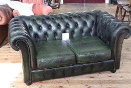 Deep buttoned bottle green leather two seater Chesterfield settee 146cm x 85cm.