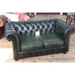 Deep buttoned bottle green leather two seater Chesterfield settee 146cm x 85cm.