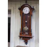 Vienna wall clock in walnut and ebonised case, having single weight movement, overall length 122cm.