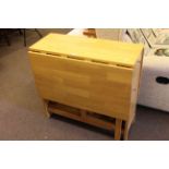 Drop leaf kitchen storage table and four folding chairs 76cm x 80cm.