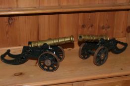 Pair of cast metal and brass model table cannons.