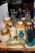 Stoneware jars and bottle, decanters, ornate brass inkwell, cruet set, Mdina glass,