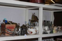 Shelf collection of Meccano with instruction books, metalwares, Meissen candlesticks, glass bottles,