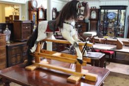 Sponge painted rocking horse on pine safety stand, 106cm by 134cm.