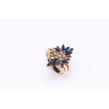 Sapphire and diamond flower design ring set in 14kt gold, size J.