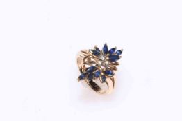 Sapphire and diamond flower design ring set in 14kt gold, size J.