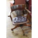 Early 20th Century swivel office armchair with buttoned leather seat.