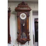Vienna wall clock in walnut with carved decoration,