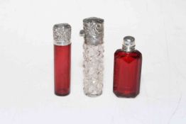 Three small silver mounted scent bottles including late Victorian ruby scent,