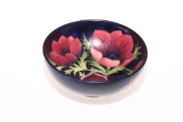 Moorcroft Pottery Anemone bowl on dark blue ground, 16cm diameter.