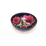 Moorcroft Pottery Anemone bowl on dark blue ground, 16cm diameter.