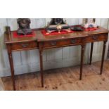 Mahogany three drawer breakfront hall table on turned reeded legs, 76cm by 153cm.