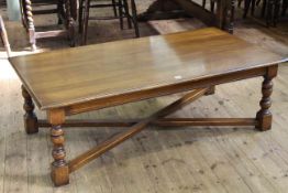 Large rectangular oak coffee table on turned legs joined by cross-stretcher, 45.5cm by 140cm.