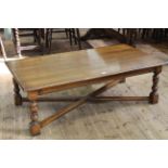 Large rectangular oak coffee table on turned legs joined by cross-stretcher, 45.5cm by 140cm.
