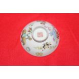 Polychrome Chinese small shallow dish painted and enamelled with artifacts, 9cm diameter.