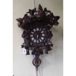 Black Forest carved Cuckoo Clock, missing weights, length including pendulum 64cm.