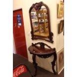 Carved mahogany demi lune console table and mirror.