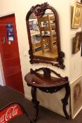 Carved mahogany demi lune console table and mirror.