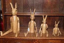 Set of four graduated jointed rabbits.