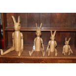 Set of four graduated jointed rabbits.