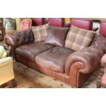 Large deep buttoned brown leather Chesterfield settee with reversible back cushions 230cm x 120cm.