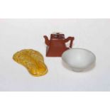 Chinese yellow glazed weight, red ware miniature teapot and unglazed bowl (3).