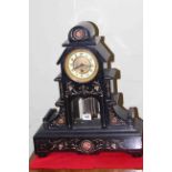 Victorian black marble clock with gilt incised decoration and exposed pendulum, 48cm.