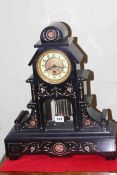 Victorian black marble clock with gilt incised decoration and exposed pendulum, 48cm.