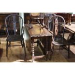 Oak barley twist gateleg dining table with carved border and three wheelback elbow chairs.