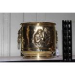 Brass embossed two handled jardiniere, 26cm.