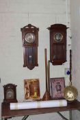 Two oak wall clocks, walnut mantel clock, brass warming pan, copper posser and horn, maps,