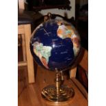 Brass and semi-precious stone terrestial globe on stand.