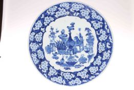 Large Chinese blue and white circular plaque with central decoration of vases of flowers and floral