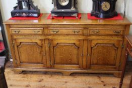Good quality oak dresser having three drawers above three arched fielded panel doors, 84cm by 168cm.