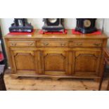 Good quality oak dresser having three drawers above three arched fielded panel doors, 84cm by 168cm.