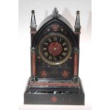 Victorian marble clock in Gothic style, having rouge and green marble half columns and decoration,