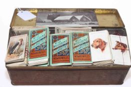 Tin of cigarette cards including Wills, Players, Ogdens, Churchman, Godfrey Phillips.