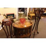 Oval hardwood tray top cocktail cabinet and two plant stands (3).