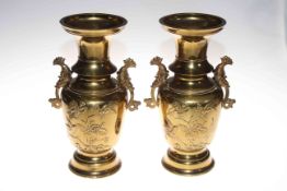 Pair Japanese brass two handled vases with relief bird and blossom decoration, 32cm.