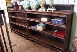 Early 20th Century walnut double bookcase with four adjustable shelves, 305cm by 141cm.