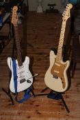 Two electric guitars, one by Jim Deacon.