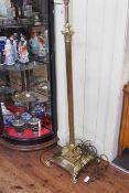 Telescopic brass corinthian column standard lamp on claw feet.